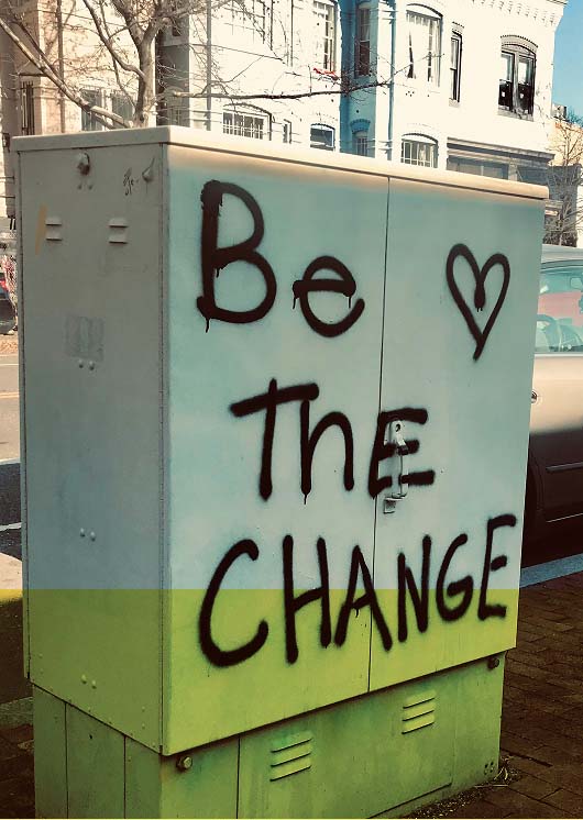 a metal box with be the change spray painted on the side