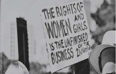 people holding up a sign that reads the rights of women and girls is the unfinished business of the 21st century
