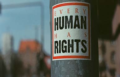 a human rights sign on a light pole