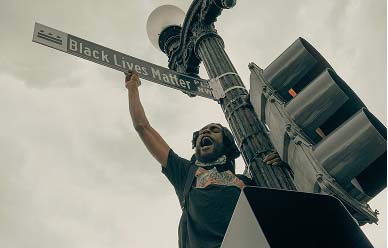 man holding a black lives matter sign